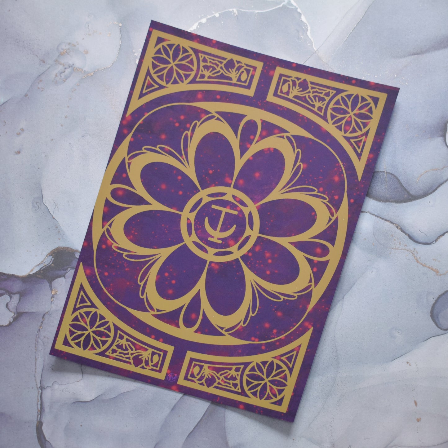 A5 print featuring a gold foil design with swirls and flower repeating motifs. Background of print is a redish purple cloudy and sparkles design. Print is miscut on one side. Background is grey watercolour style.