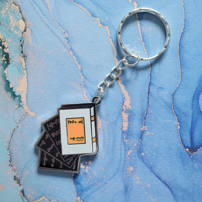 Falling Pages - Enamel Keyring