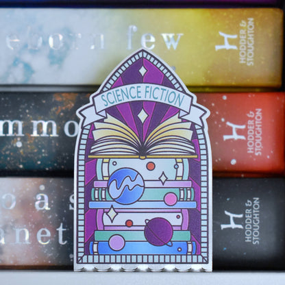 Decorative stainless steel standee with 'Science Fiction' design on in the style of a stained glass window with a stack of books behind.
