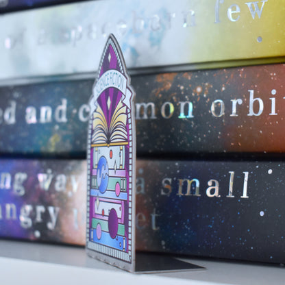 Decorative stainless steel standee with 'Science Fiction' design on in the style of a stained glass window at an angle to see it is an L shape with a stack of books behind. 