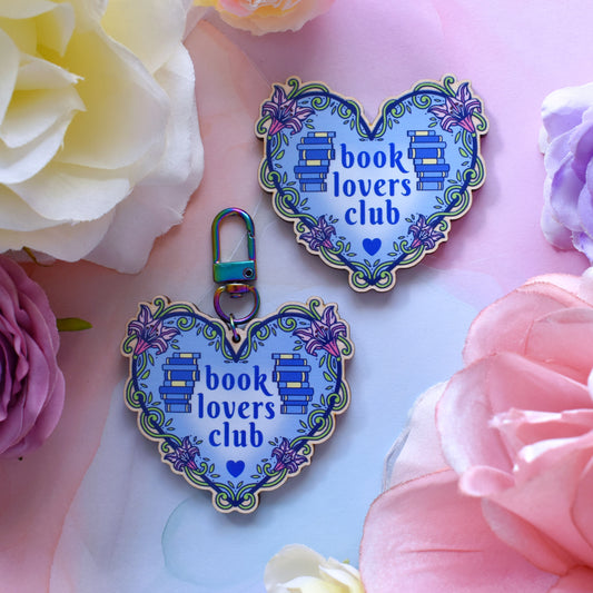 Heart-shaped blue & floral themed 'book lovers club' wooden pin & keyring on a watercolour background with floral border
